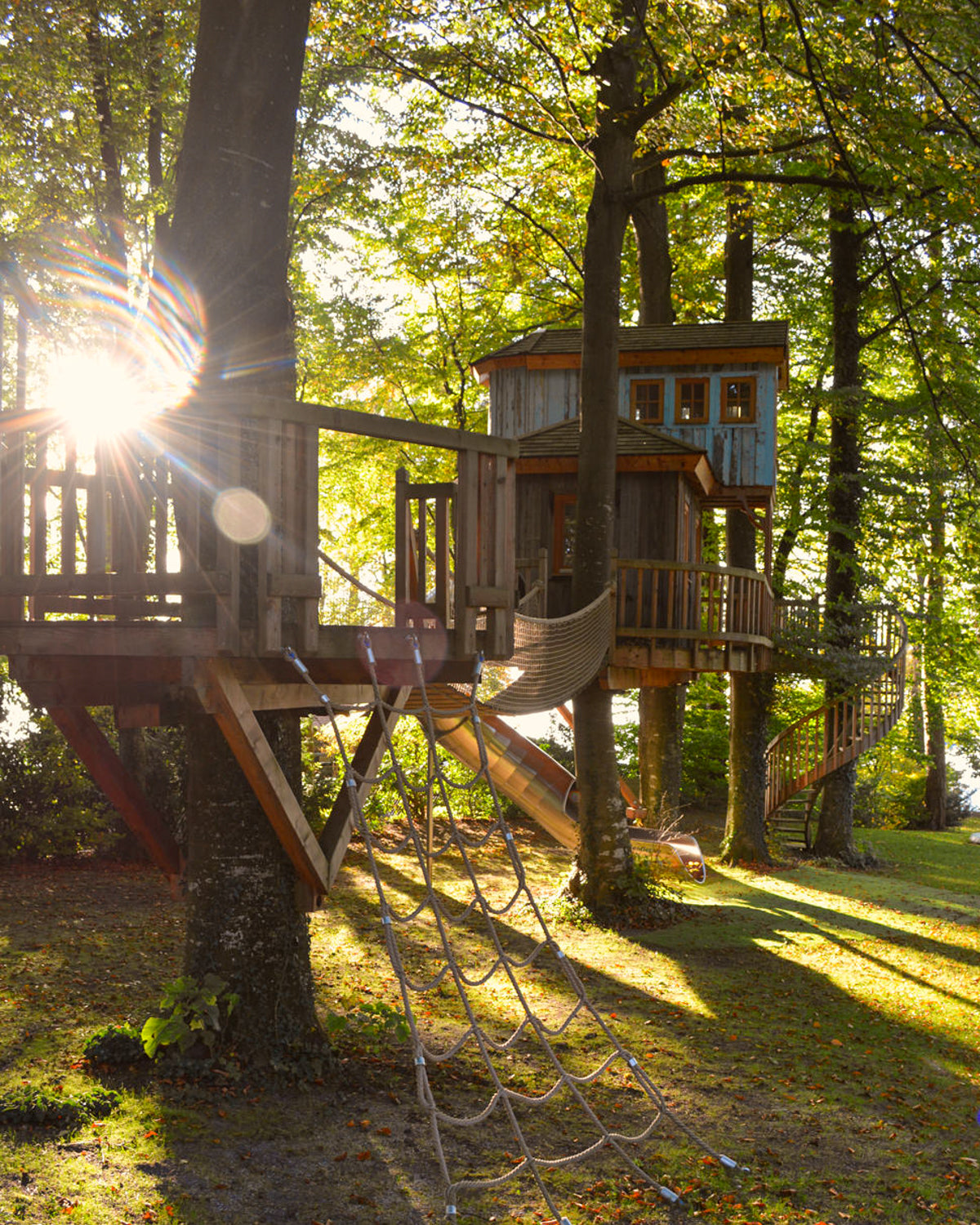 Baumhaus selbst bauen Sonnenuntergang Spiel Spass Kinder Hängebrücke Rutsche Wendeltreppe