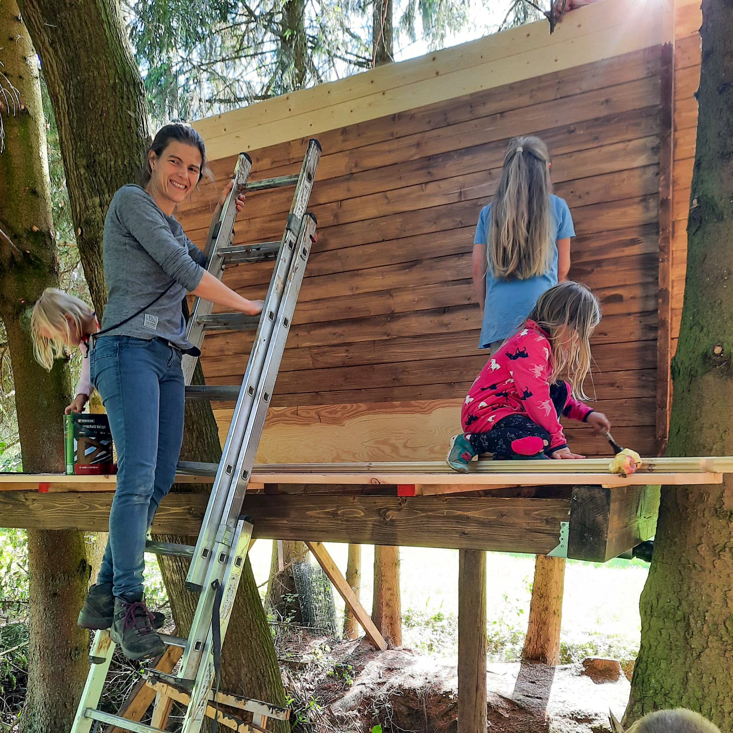 Family building treehouse with kids
